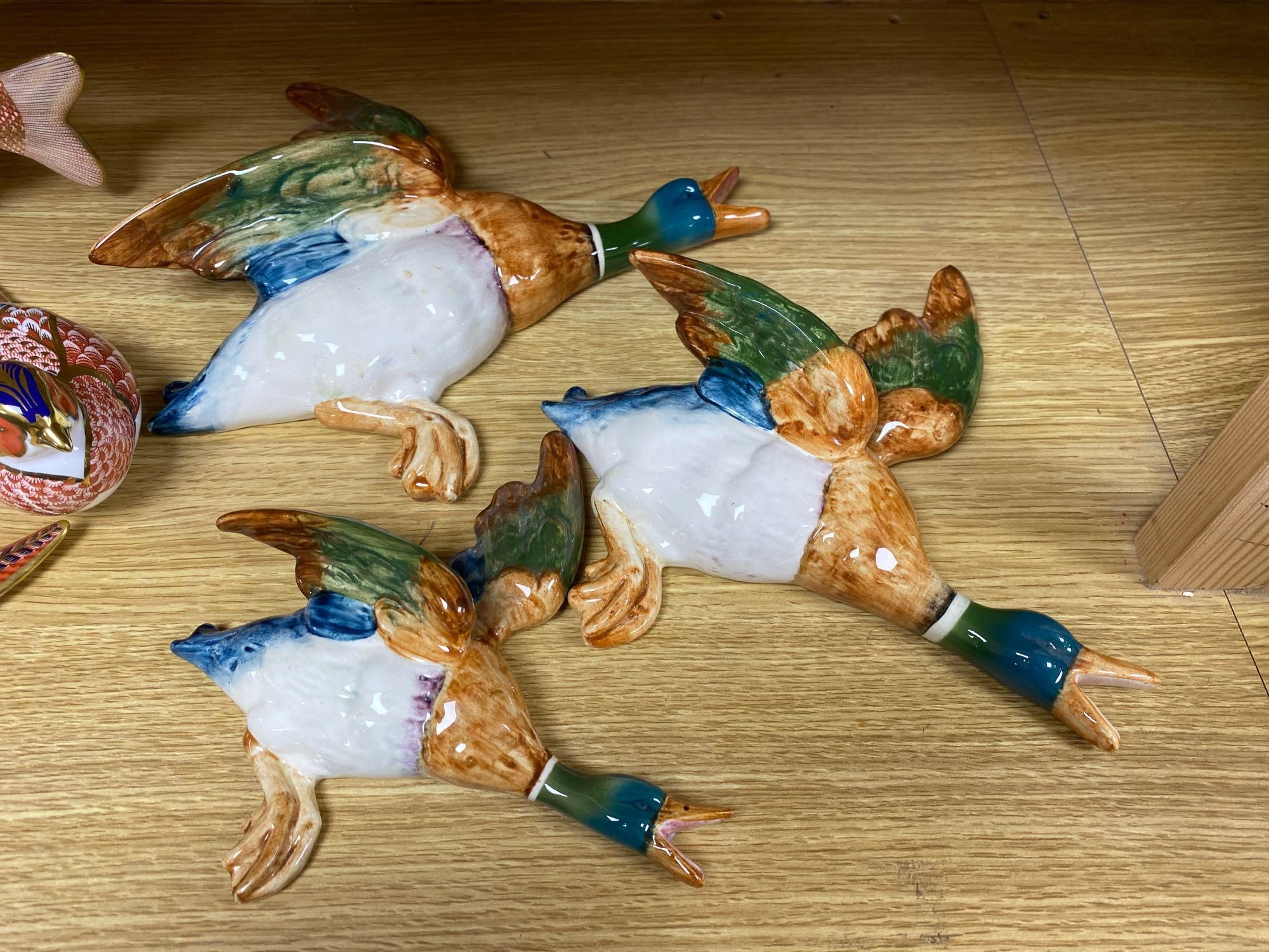 A graduated set of Beswick flying ducks and five Royal Crown Derby animal paperweights and another similar rabbit, fish 18cm